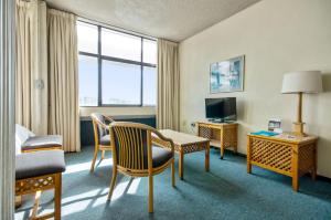 a hotel room with a bed and a table and chairs at Gardens Centre Holiday Apartments in Cape Town