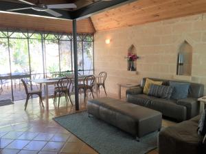 a living room with a couch and a table at Fremantle Accommodation Villas in Fremantle