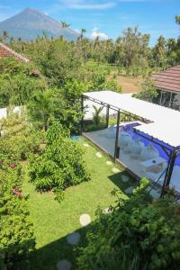 an aerial view of a garden with a swimming pool at BALI AMED FEEL HOME VILLA in Amed