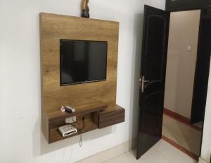 a television on a wall in a room at Hotel Bansal Residency, Sirsa in Sirsa