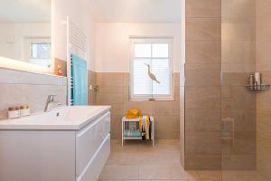 a bathroom with a sink and a shower at Mirabelle in Zingst