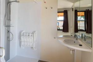 a bathroom with two sinks and a mirror at Fornella Camping & Wellness family resort in San Felice del Benaco