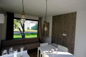 a dining room with two tables and a window at Fornella Camping & Wellness family resort in San Felice del Benaco