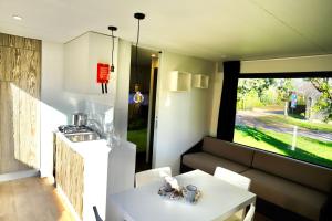 a living room with a couch and a table at Fornella Camping & Wellness family resort in San Felice del Benaco