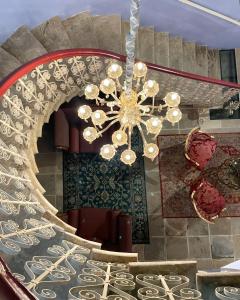 a chandelier hanging from a staircase in a building at Madama Residence in Nicosia