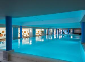 a swimming pool with blue lighting in a building at Iberostar Selection Kuriat Palace in Monastir