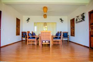 a dining room with chairs and a table at Tiako Villas in Ambondrona