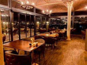 a restaurant with tables and chairs and wine bottles at A11 HOTEL BOSPHORUS in Istanbul