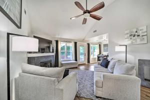 a living room with two chairs and a ceiling fan at Claremore Getaway about 2 Mi to Historic District in Claremore