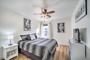 a bedroom with a bed and a ceiling fan at Claremore Getaway about 2 Mi to Historic District in Claremore