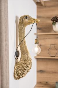 a bird head wall light with a light bulb at Hotel Viktoria & Landhaus Joggl in Mayrhofen