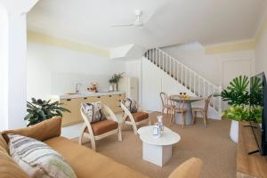 a living room with a couch and a table at Motel Molly - Boutique Hotel Mollymook in Mollymook +53 photos