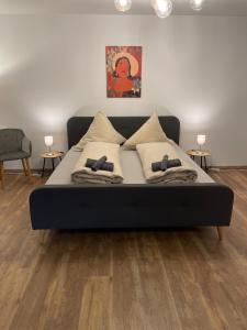 a bed with two pillows on it in a room at Ferienwohnung auf dem Sonnenhang in Bad Rothenfelde