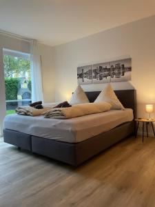 a large bed in a bedroom with a large window at Ferienwohnung auf dem Sonnenhang in Bad Rothenfelde