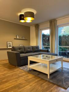 a living room with a couch and a coffee table at Ferienwohnung auf dem Sonnenhang in Bad Rothenfelde