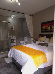 a bedroom with a large bed and a shower at Sarah's Place Guesthouse in Pretoria