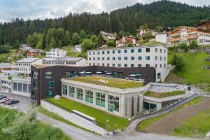 an aerial view of a building with a green roof at wellnessHostel3000 in Laax