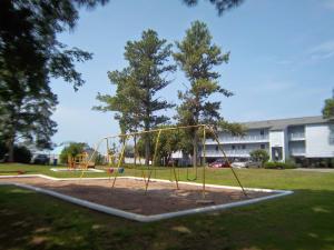 a playground in a park with at Sandcastle Cove in New Bern +6 photos