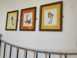trois images d'animaux sur un mur blanc dans l'établissement "The Quirky" Seafront Apartment, à Eastbourne
