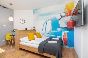 a bedroom with a bed with a car mural at Kraków Trendy Studio Apartments by Renters in Krakow
