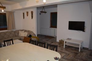 a living room with a couch and a table at cabana din padure in Finiş