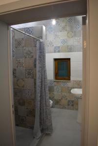 a bathroom with a shower curtain and a sink at cabana din padure in Finiş +20 photos