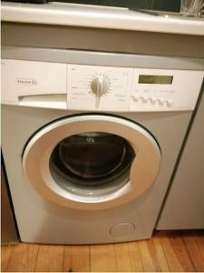 a washing machine with its door open in a kitchen at The pop-art luxury suite in Charleroi