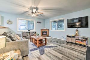 a living room with a couch and a flat screen tv at Dog-Friendly Harrison Retreat with Grill and Fire Pit! in Harrison