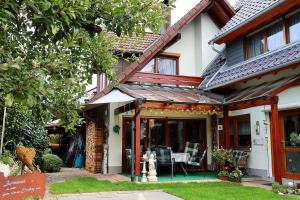 a house with a porch with a table and chairs at Haus Gerlinde in Zell am Harmersbach