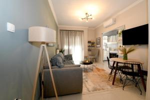 a living room with a couch and a table at Lovely luxury apartment in Serres