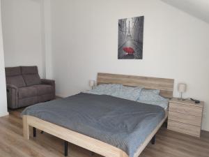 a bedroom with a bed and a couch at Fewo Bernau in Bernau bei Berlin