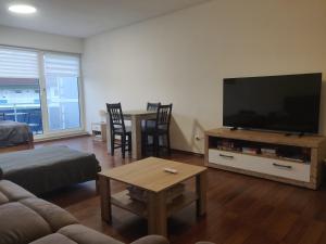 a living room with a flat screen tv and a table at Fewo Bernau in Bernau bei Berlin