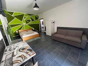 a living room with a couch and a bed at Hostel Turin Metro Young in Turin