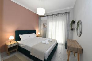 a bedroom with a bed with two towels on it at Lovely luxury apartment in Serres