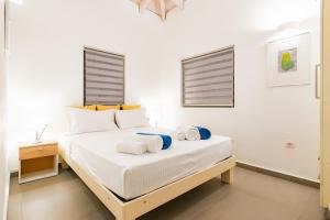 a bedroom with a bed with towels on it at Ville Du Coop in Zakynthos Town +47 photos