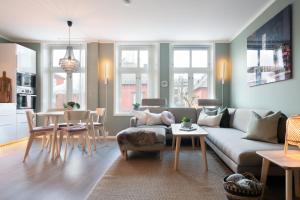 a living room with a couch and a table at The Golden Lion Street Getaway in Trondheim