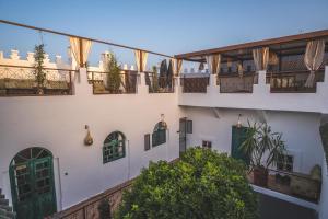 a view of a building with balconies and plants at Riad Villa Berna under Swiss Management in Marrakesh