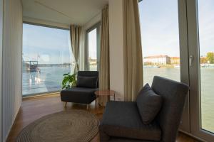 a living room with a view of the water at Sundeck botel - party boat in Bratislava