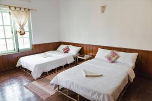 Postel nebo postele na pokoji v ubytování Ananda Tree House Eco Homestay