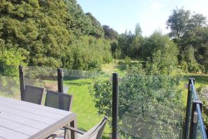 a view of a garden from the balcony of a house at Riverbank Cottage in Lancaster