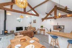 a living room with a table and chairs and a fireplace at Riverbank Cottage in Lancaster +17 photos