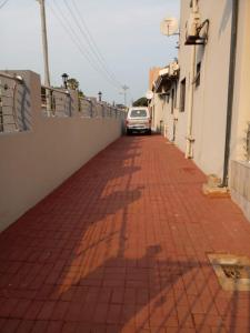 a car parked on a brick sidewalk next to a building at Franque Lodge in Durban