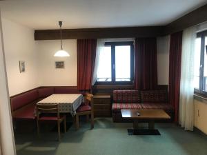 a living room with a couch and a table at Niki Appartments in San Candido