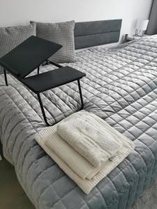 a bed with a tray on it with a table on it at Chic&Chic in Szczecin