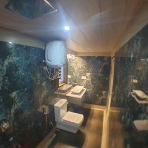 a bathroom with two sinks and two toilets at Zingo's Home Stay in Darjeeling +97 photos