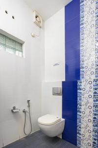 a bathroom with a toilet and a shower at Homested Homestay Fort Kochi in Cochin