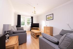 a living room with two couches and a tv at ALTIDO Modern flat with free parking in Edinburgh