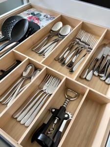 a drawer filled with silver utensils at Ferienwohnungen Anne in Schönebeck