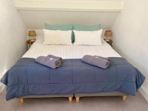a large bed with two pillows on top of it at Zilt Noordwijk in Noordwijk aan Zee