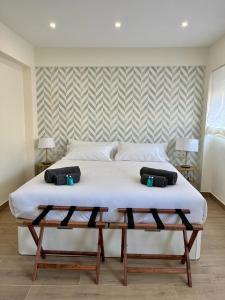 a bedroom with a large bed with two pillows on it at Apartamento Turístico Clavellinas IV in Cáceres